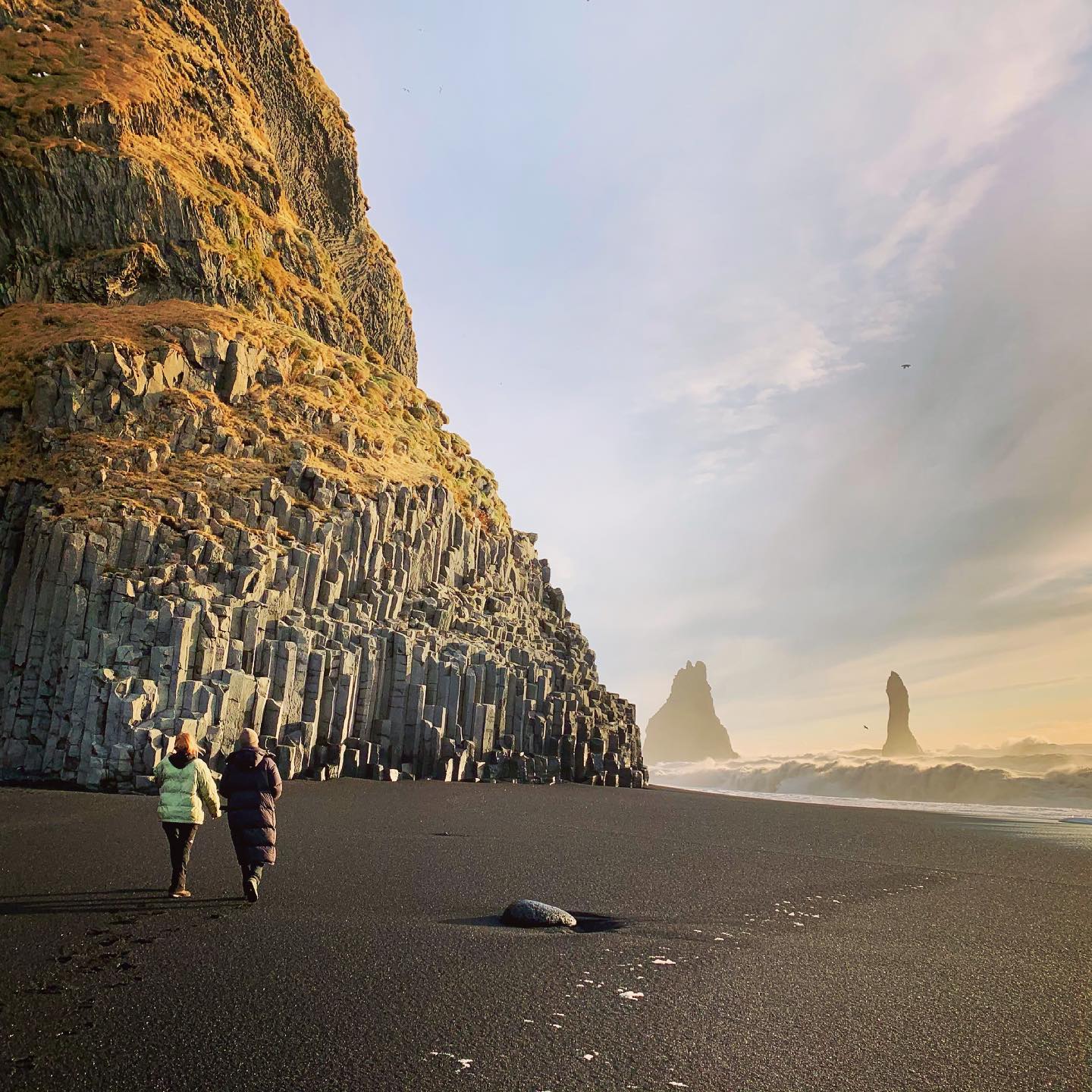 Hikers on the legendary Black Sand Beach in Iceland
