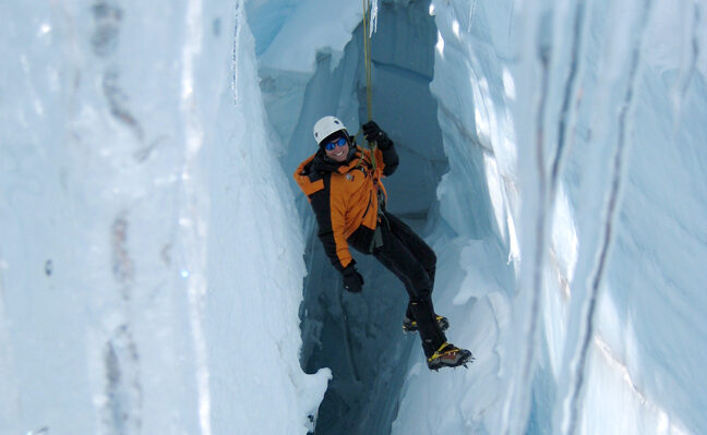 A climber practicing crevasse rescue skills
