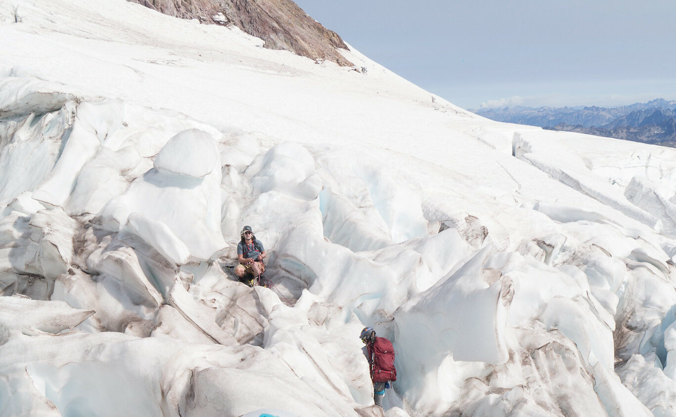 Two climbers traveling through glaciated terrain