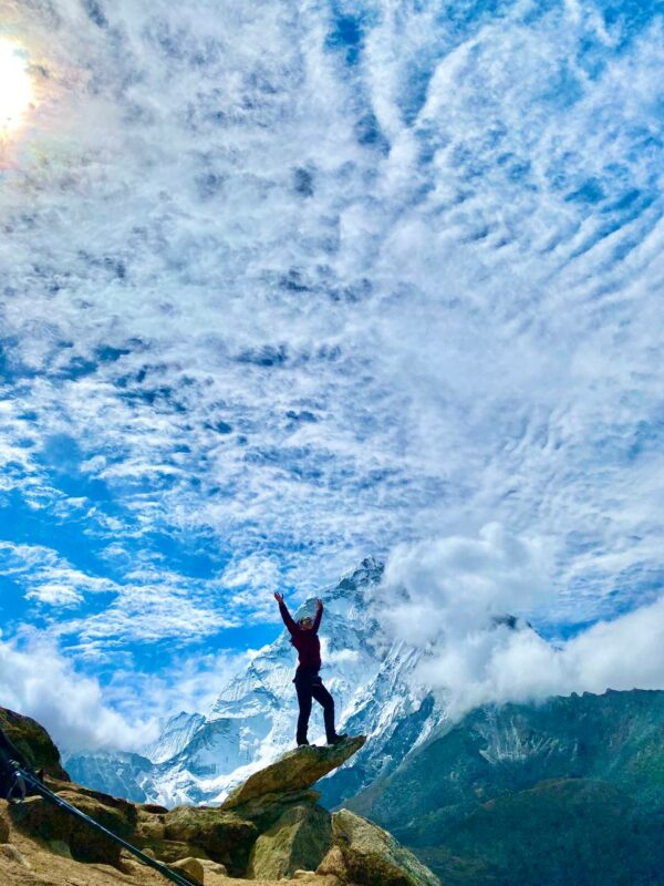 Happy hiker and mountain peaks.
