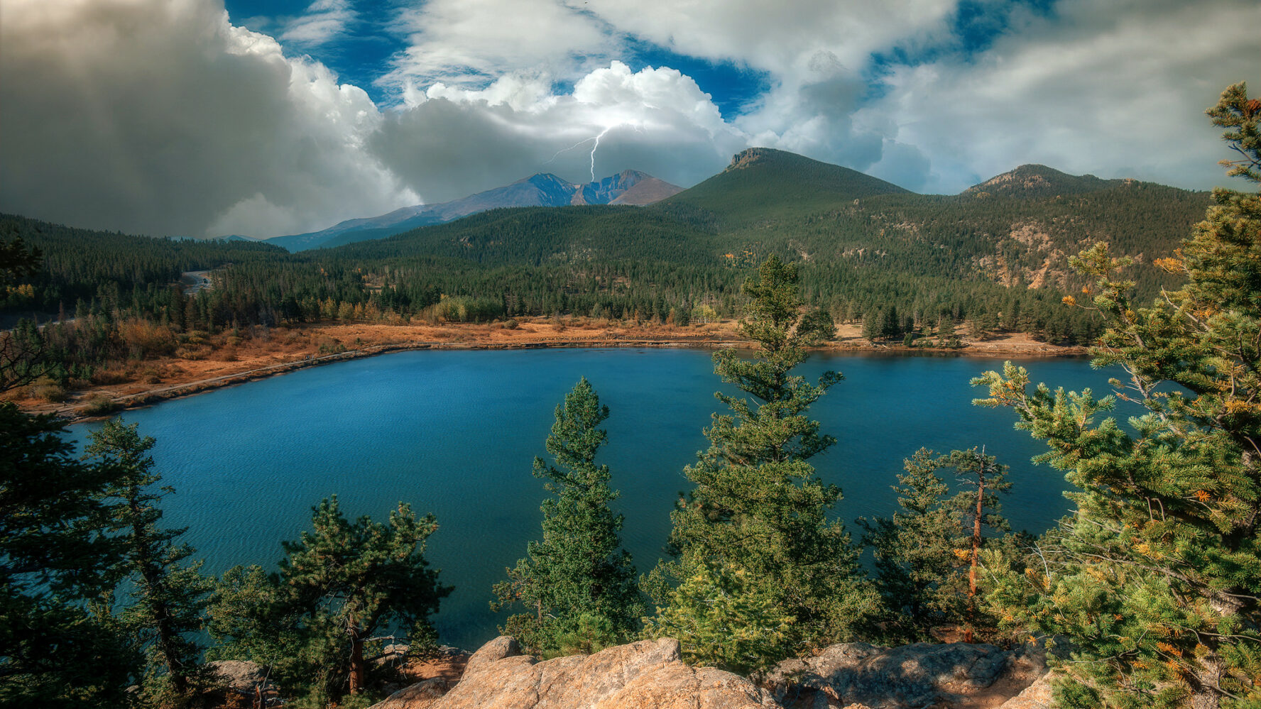A view of Lily Lake in RMNP and a storm in the distance