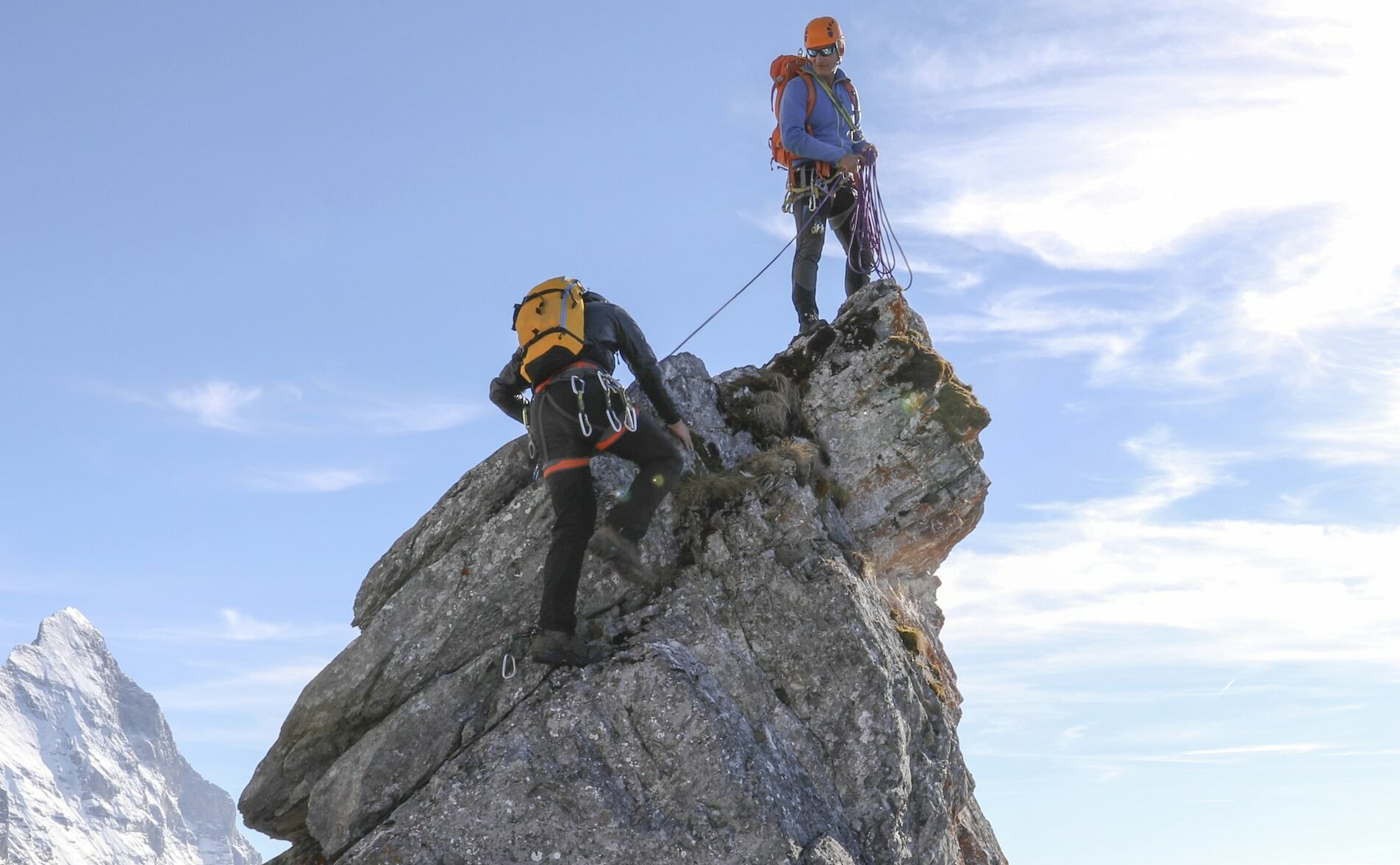 Two climbers ascending a peak in the Alps