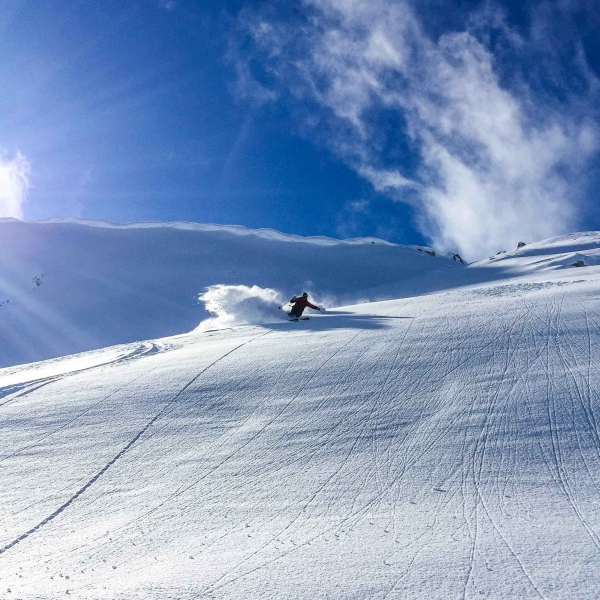 A backcountry skier going downhill in Duffey Lake