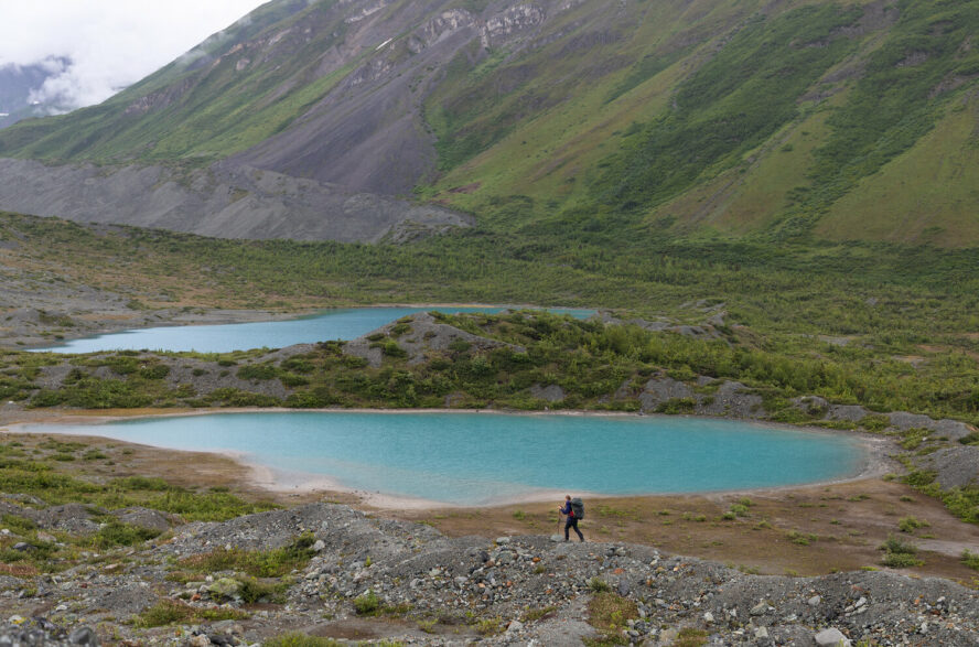 A backpacker next to a lake in Denali National Park