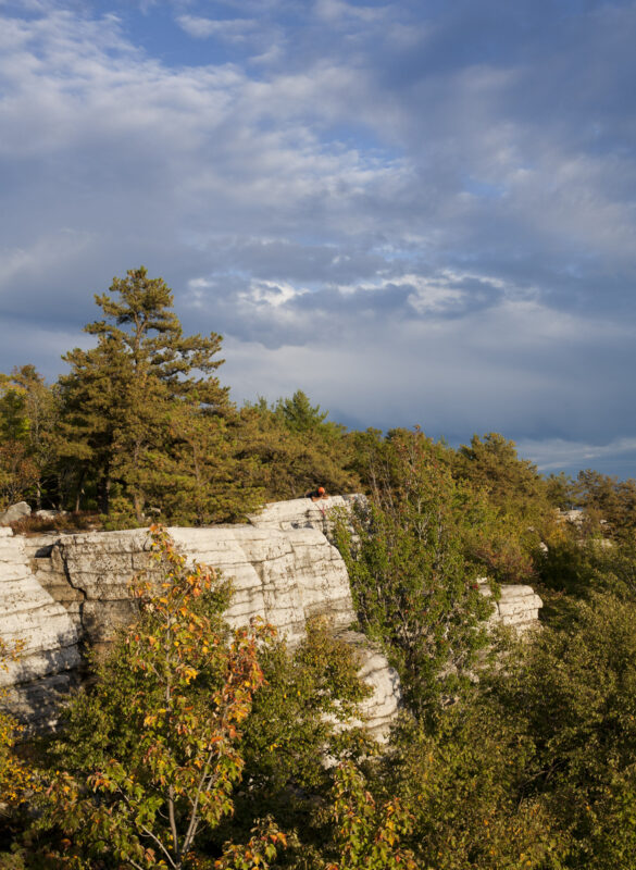 A rock climber setting up top rope in the Gunks