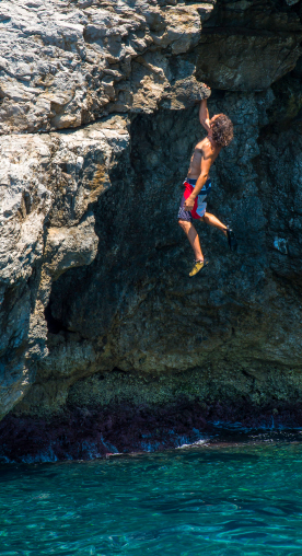 A man climbing a vertical in the Amalfi coast