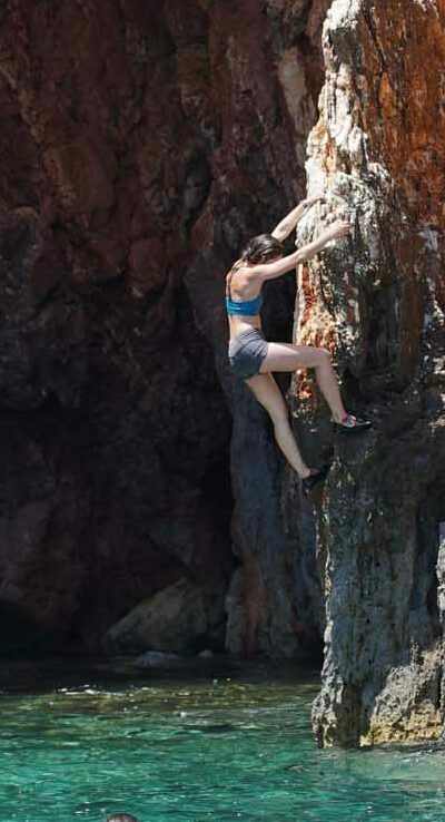 A woman climbing deep water solo
