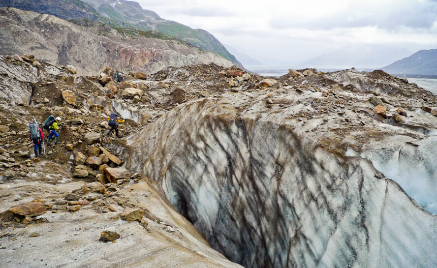 Backpackers hiking on a glacial moraine in Denali National Park