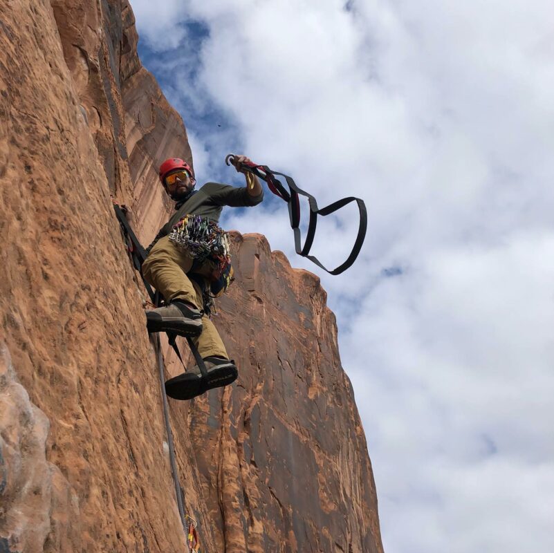 Climber on a sandstone wall in Moab
