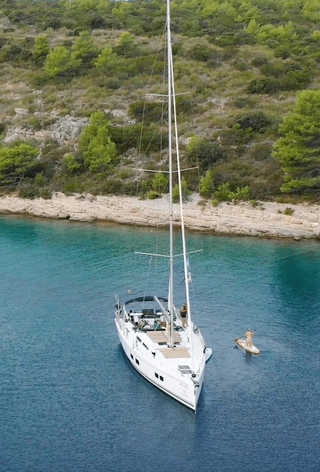 A sailboat anchored close to the rocky Croatian coast