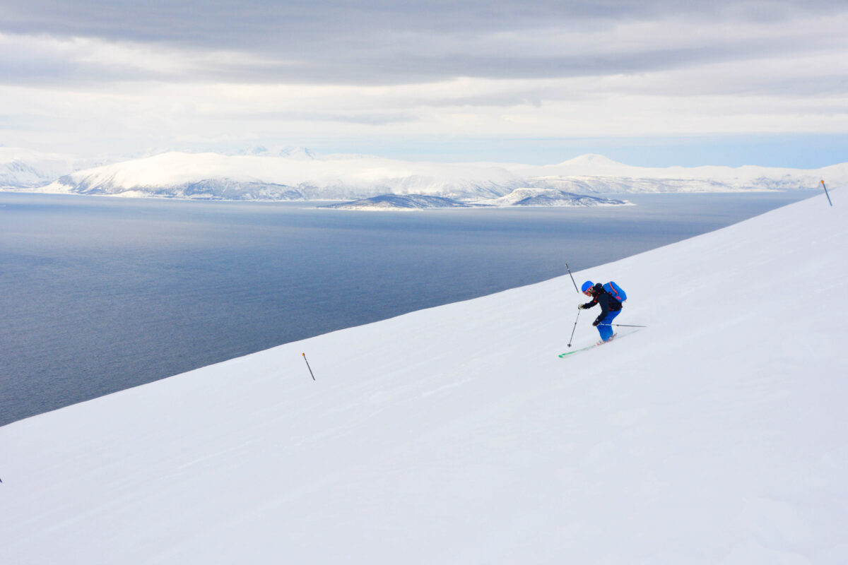 A skier descending on Norway’s coastline