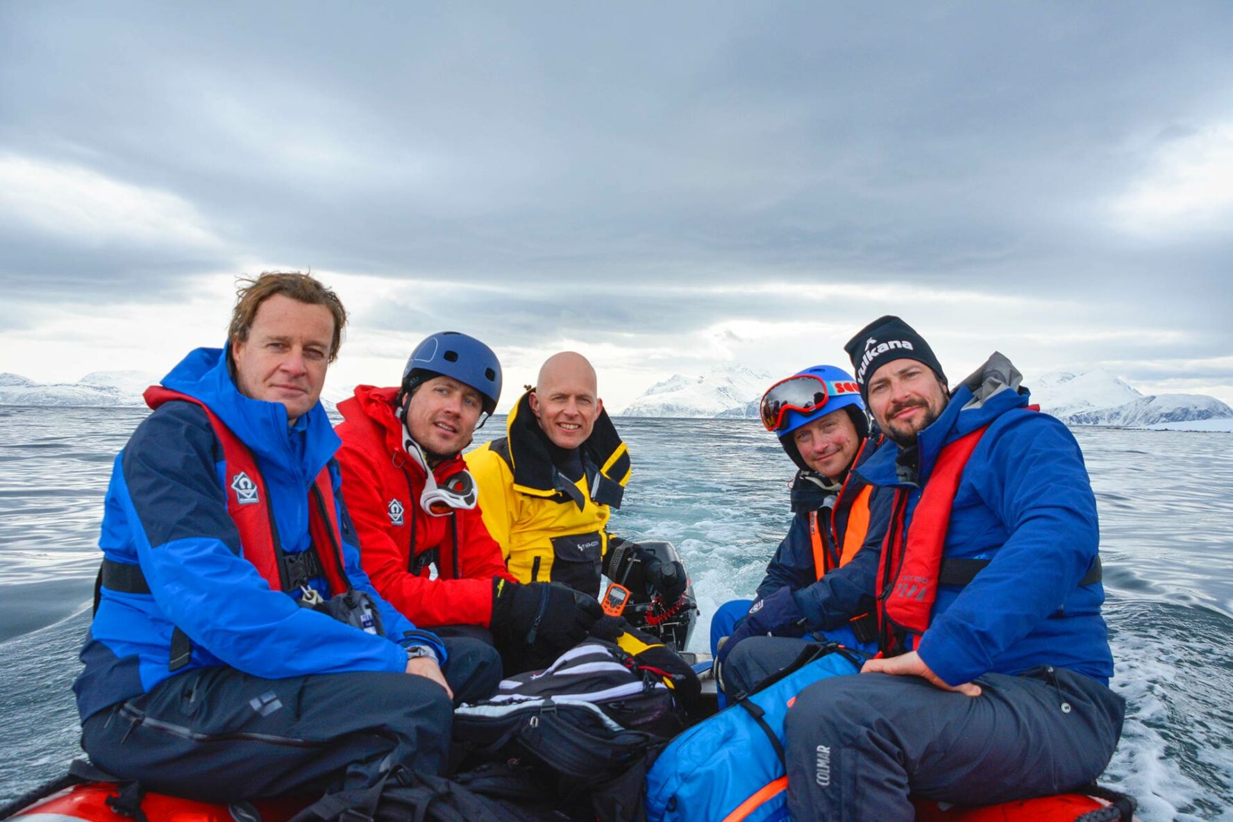Skiers on a dinghy on Norway’s coastline