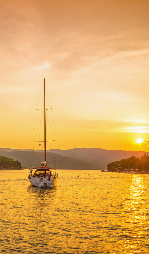 Boat sailing in to the sunset in Stari Grad, Hvar (Croatia)