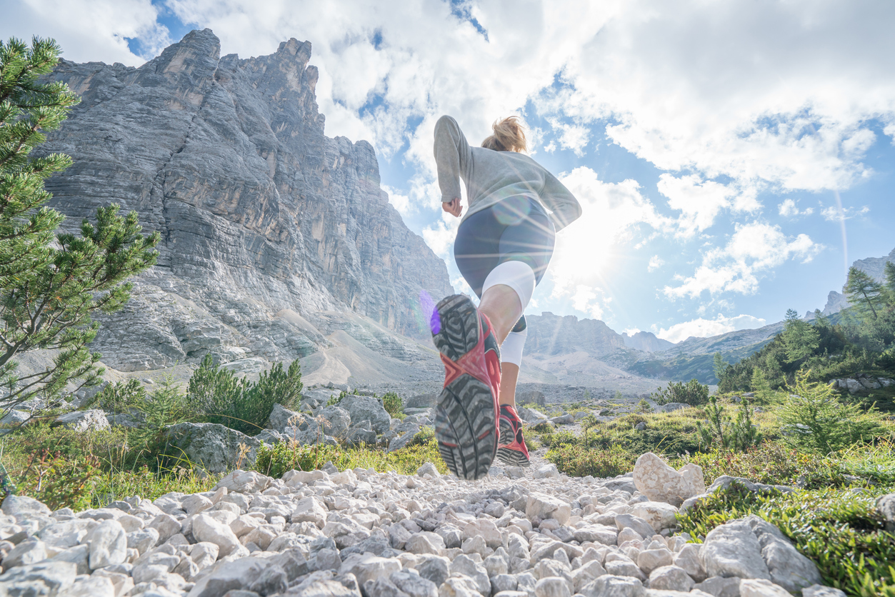 A woman trail running in the Dolomites