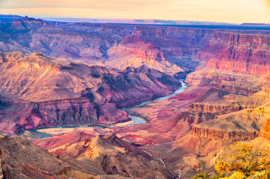 Aerial view of the Grand Canyon depicting its colorful rock layers going from orange to purple.