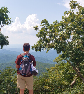 A hiker admiring one of the many views of the Appalachian Trail.