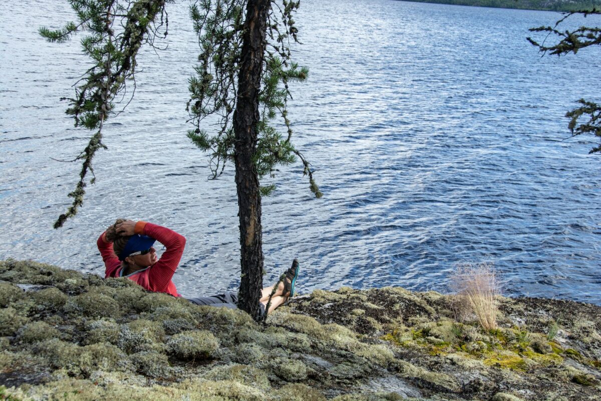 A canoer relaxing by a river in Canada