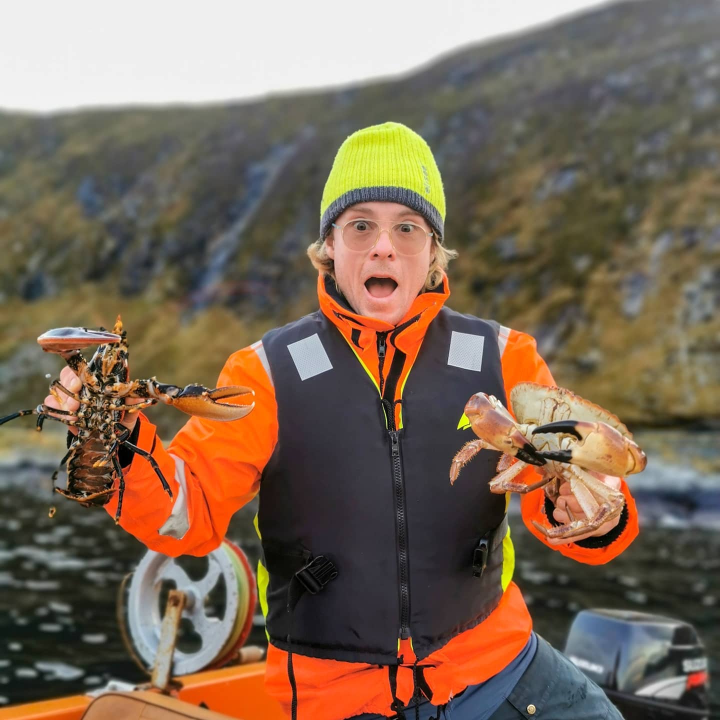 A guide holding lobsters, Western Norway