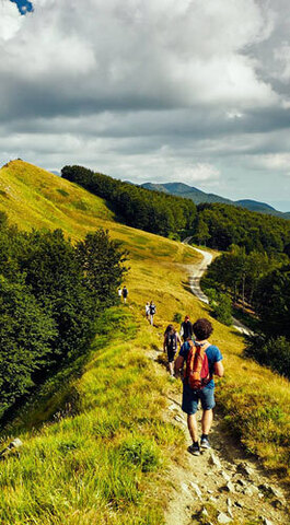 Hikers walking on a ridge of the Apennine Mountains in Tuscany