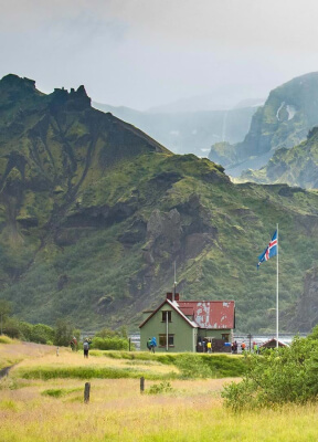 Hrafntinnusker Hut is a welcome place of respite amidst the stunning yellow mountain ridges.