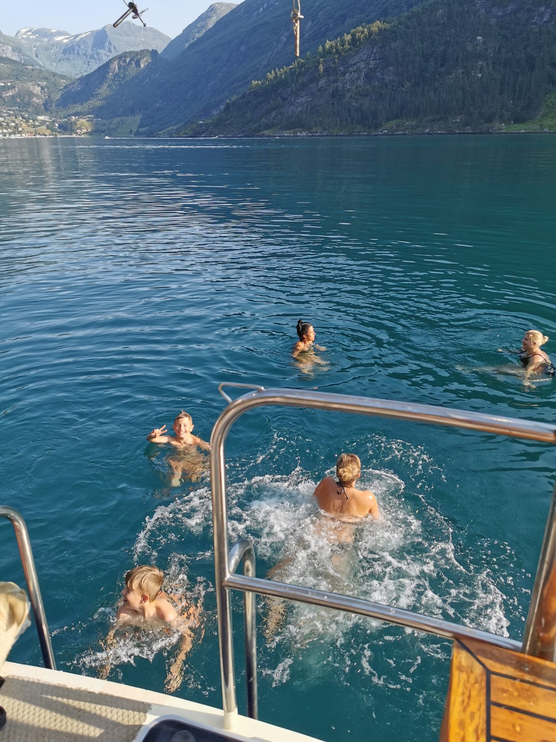 Children swimming and having fun on the Norwegian coastline