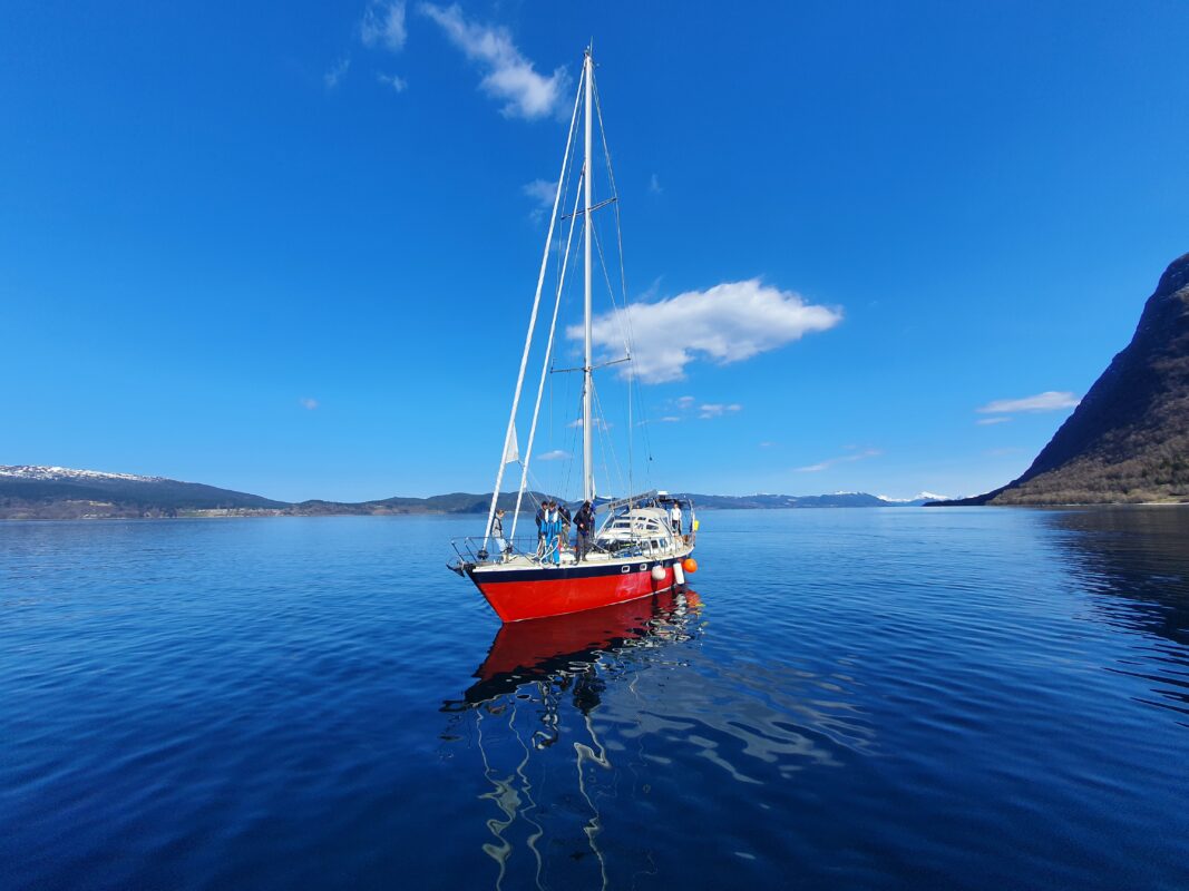 A sailboat on crystal clear waters in Norway