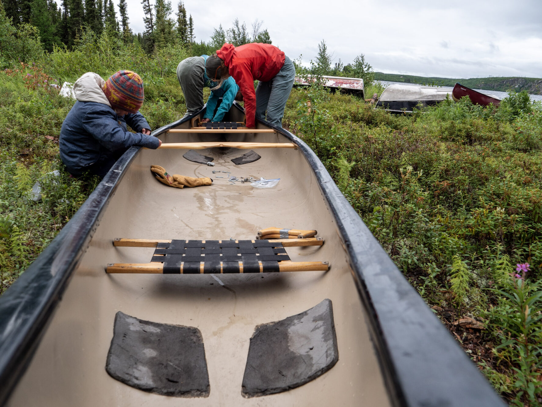 People preparing a canoe on the Paull River