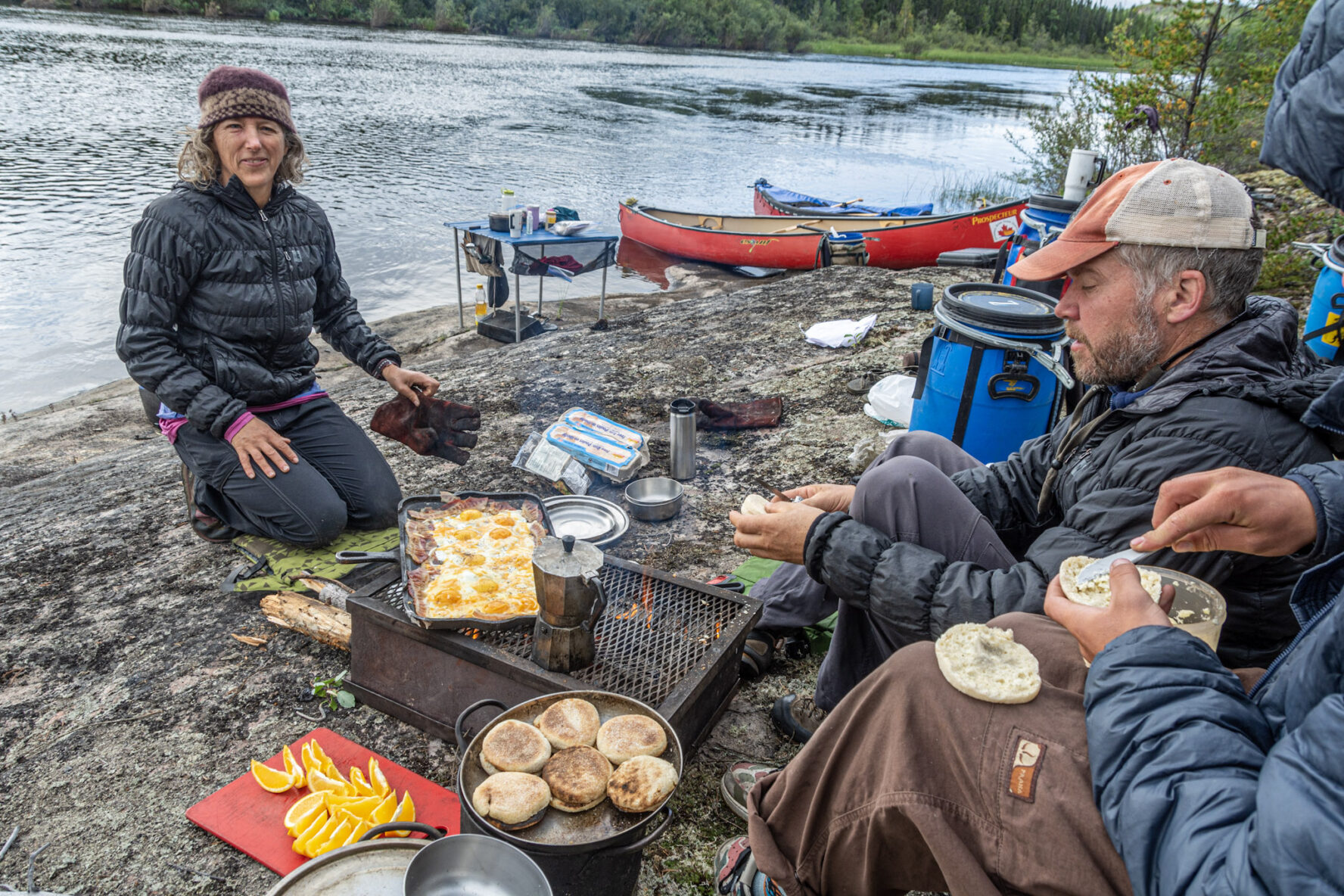 People preparing food next to the Porcupine River