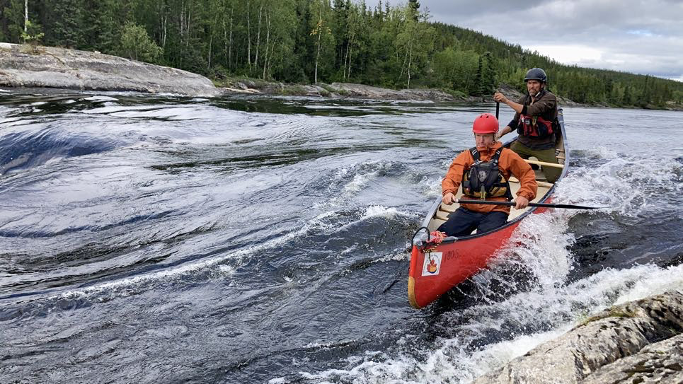 Two men in a canoe on the Seal River in Manitoba