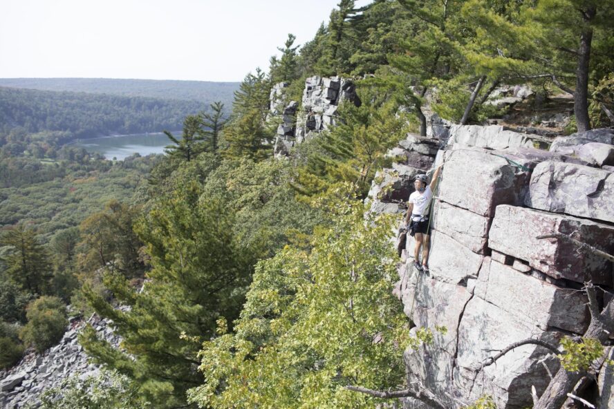 Climber looks over Devil’s Lake State park. 