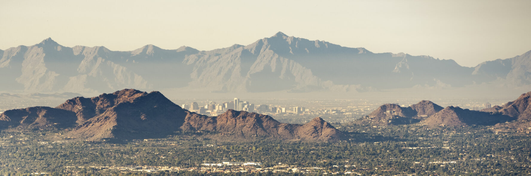 The Phoenix skyline showing the McDowell Mountains and Camelback Mountain through smog.