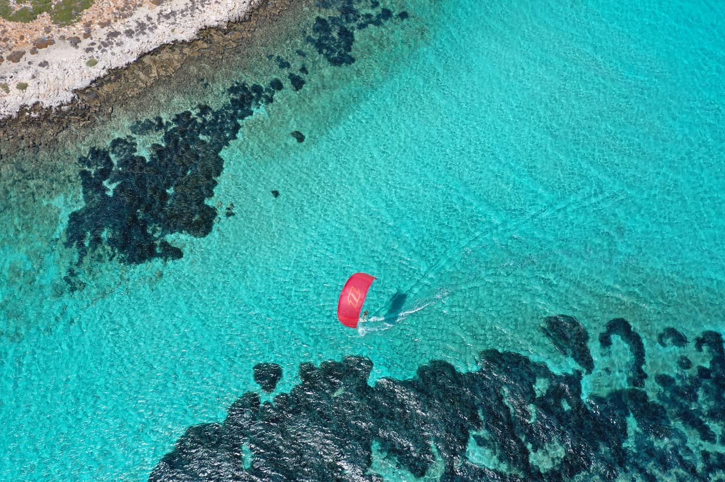 An aerial view of a kitesurfer in the Cyclades