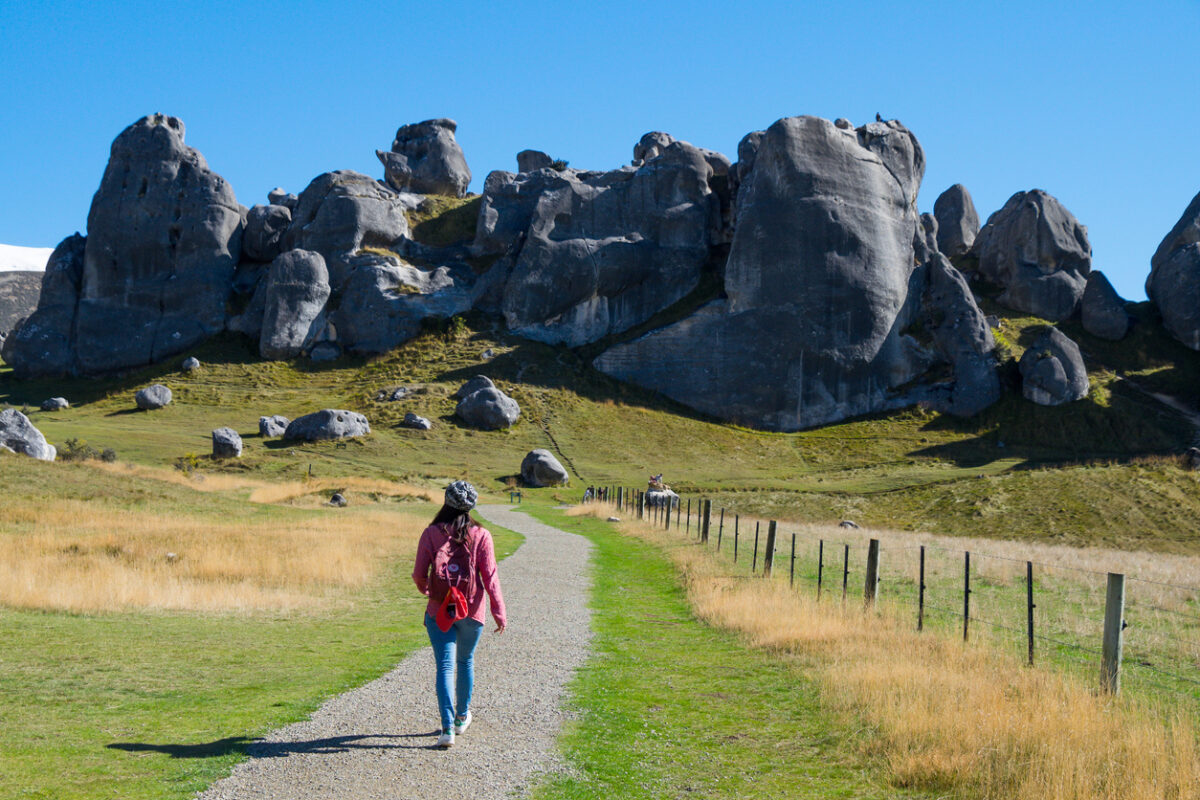A hiker on a trail to Castle Hill, South Island, New Zealand