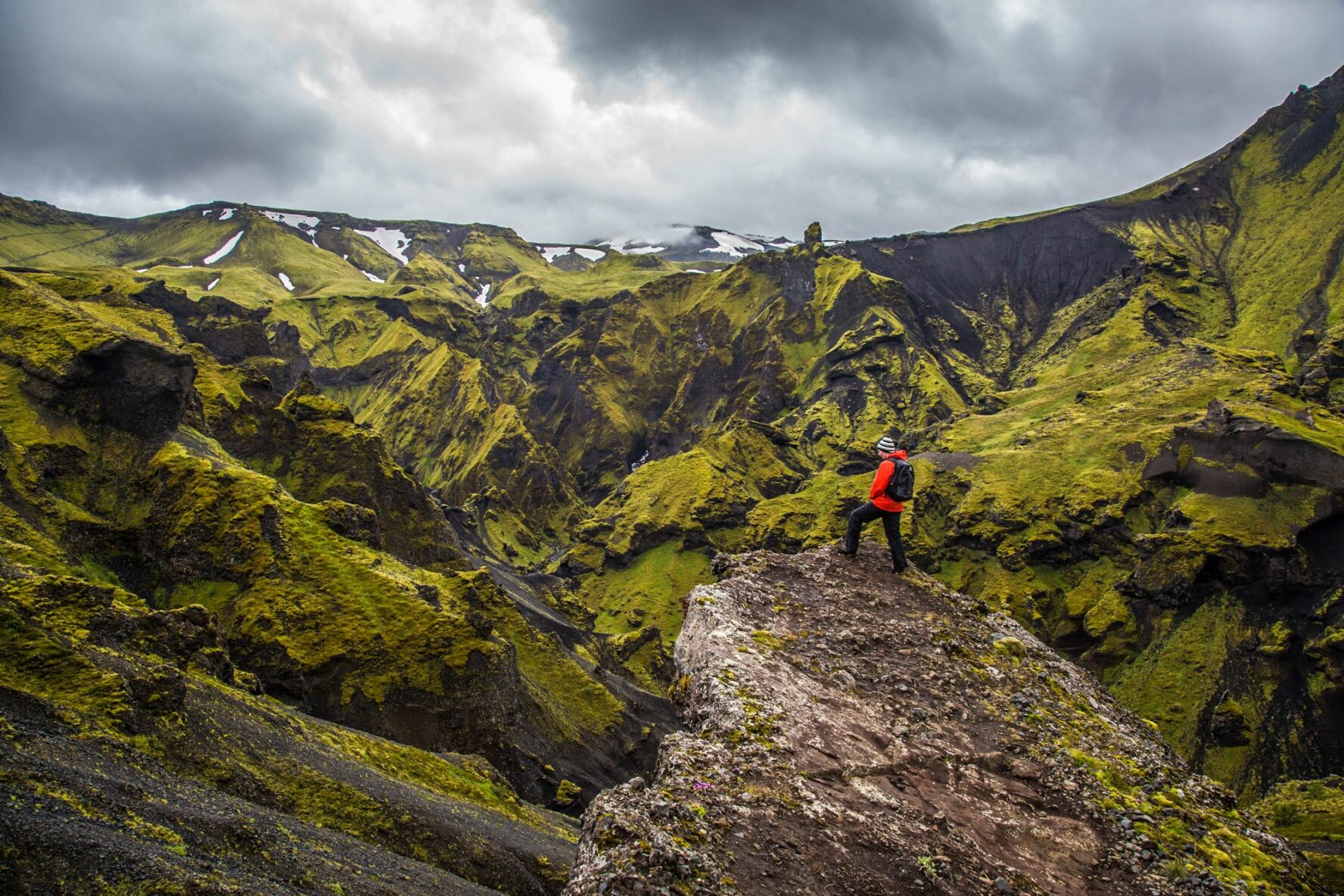 A hiker staging on a cliff in Thorsmork