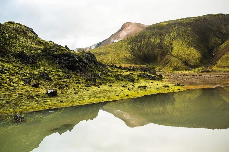 The Jökultungur area, a luscious green valley, spattered with rocks that have been dyed various shades of ruby and amber, by the volcanic activity that has occurred over the centuries.