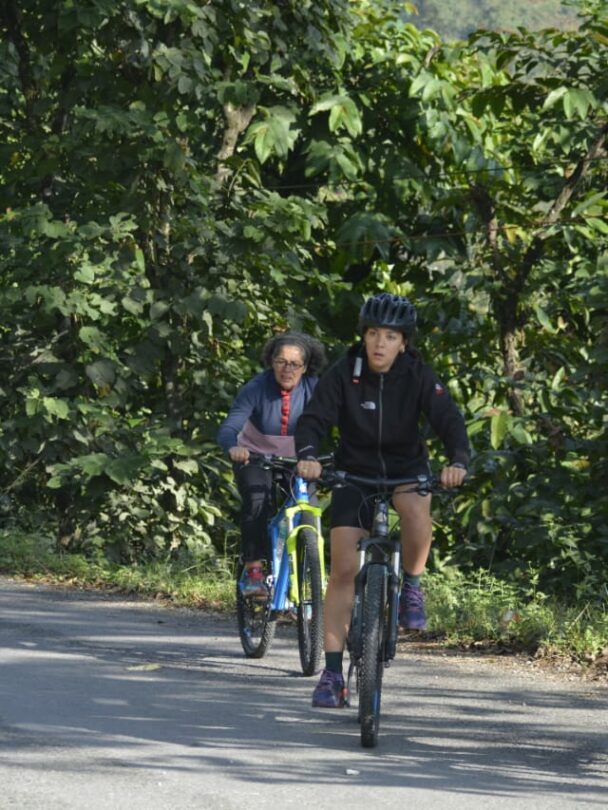 Three cyclists on a street of Italian town