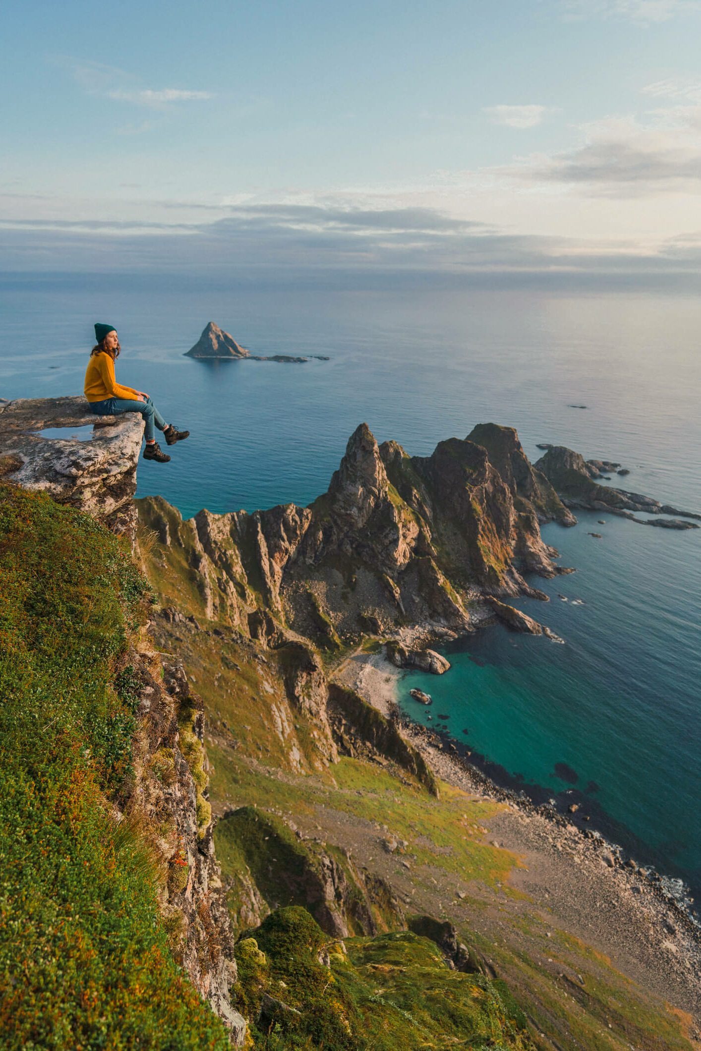 A hiker admiring the view from the fjord in Lofoten, Norway.