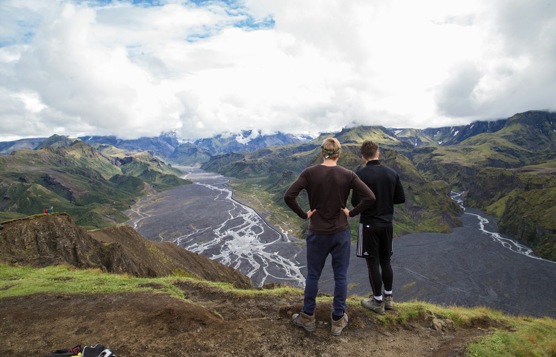 Hikers admiring the view of dark Thorsmork and its meandering rivers