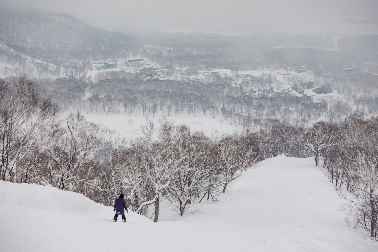 Snowboarder Riding Down the Mountain at Niseko United, Hokkaido, Japan