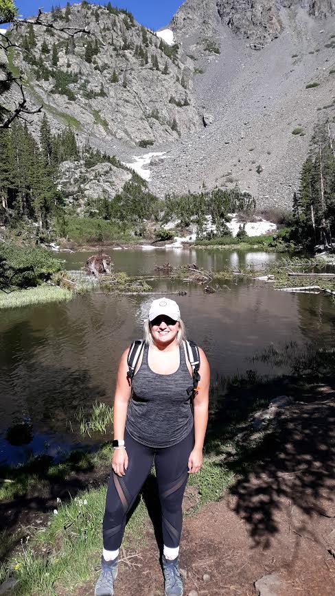 A woman standing in front of Mohawk Lake in Summit County