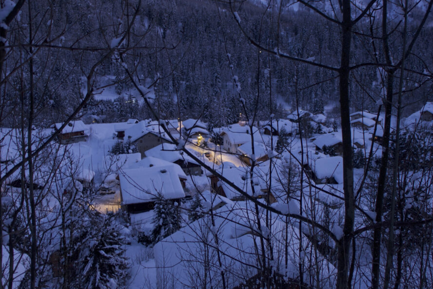 Tréléchamps, a snowy alpine village, in the early evening of winter.