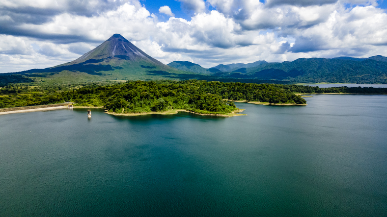 Arenal Volcano National Park in Costa Rica with Arenal Lake. The volcano is surrounded by lush tropical rainforest.