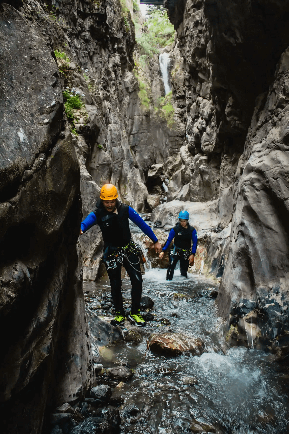 Two people during the activity of gorge scrambling.