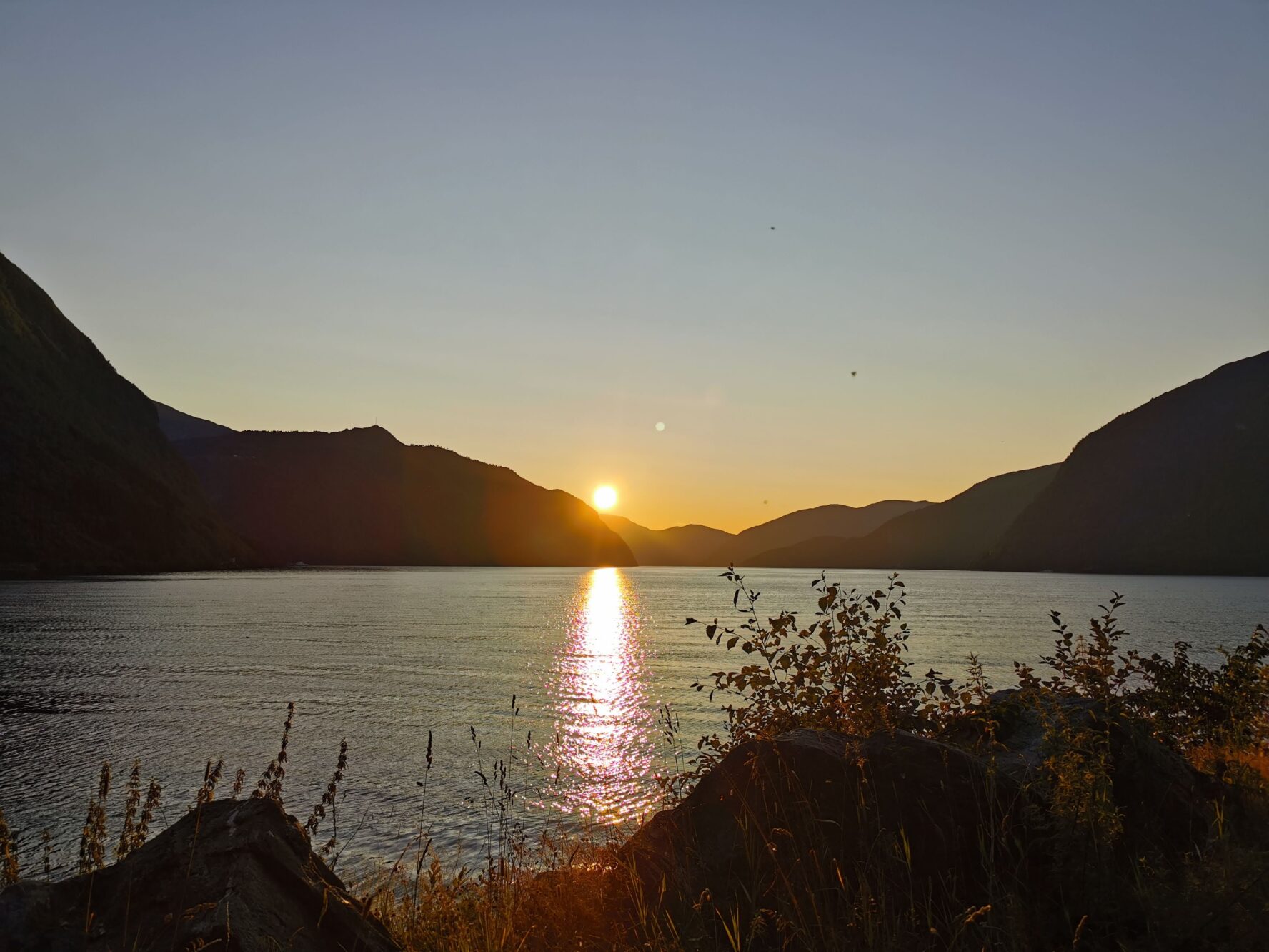 Sunset behind some mountains in a fjord in Norway