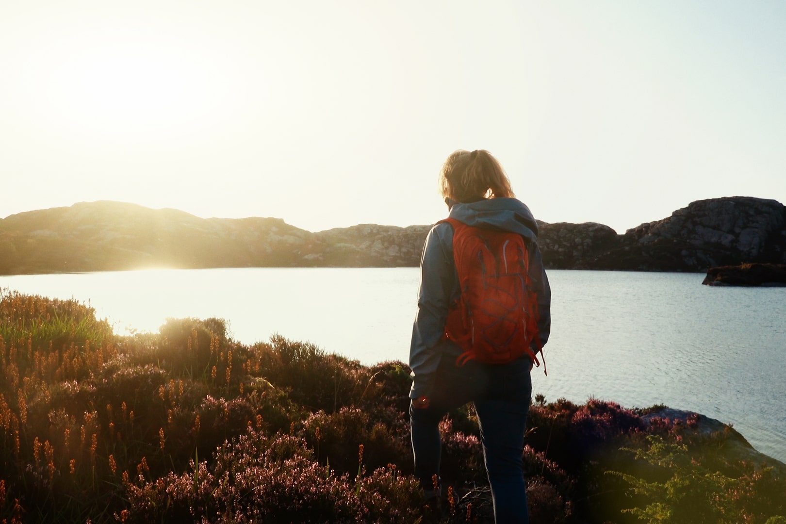 A hiker overlooking a lake in Norway