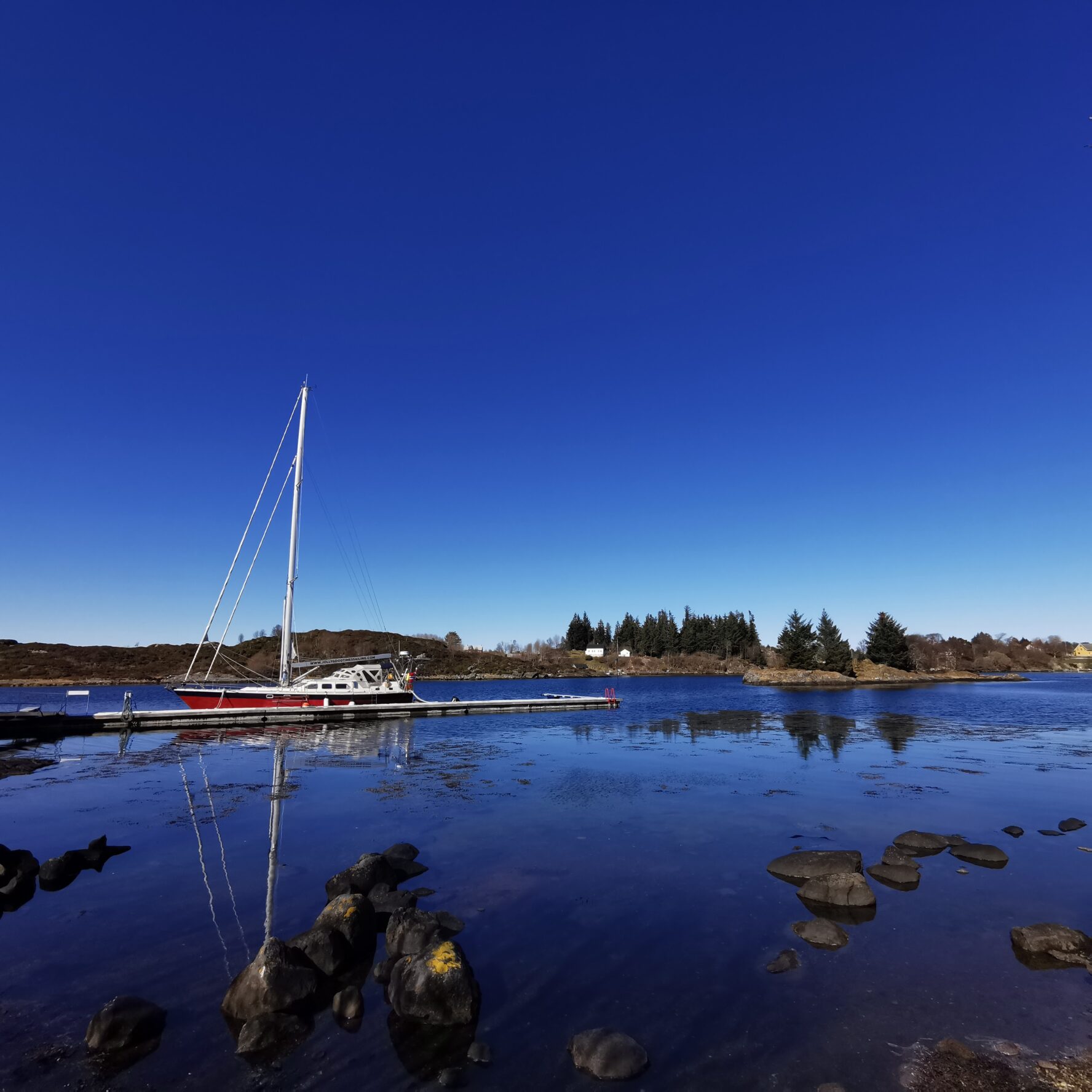 A sailboat anchored near a fjord in Norway