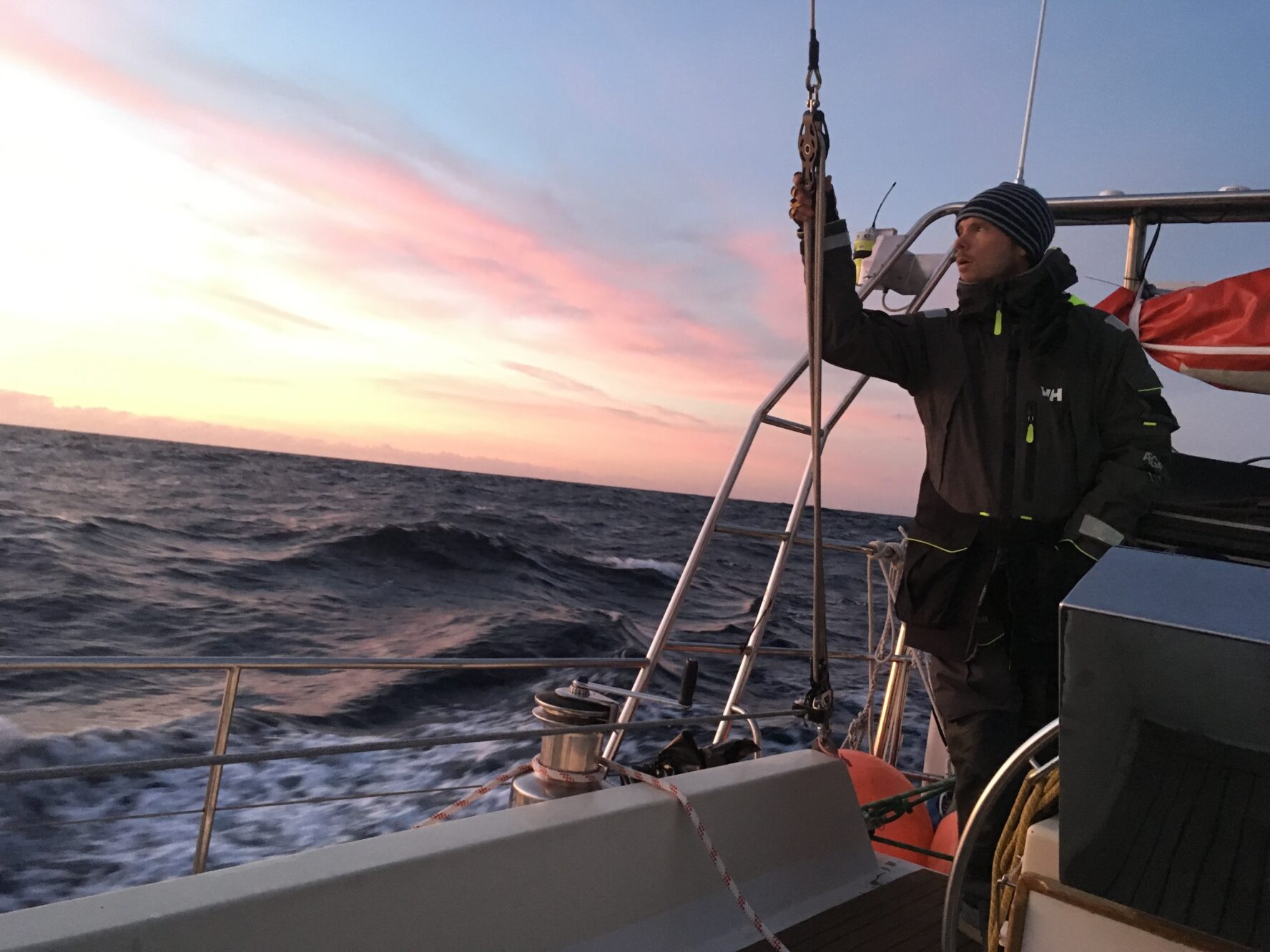 A sailor posing at sunset on the Norwegian coastline