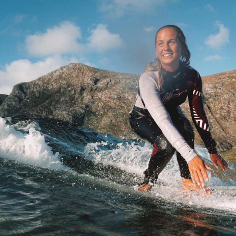 A female surfer enjoying her time in Norway