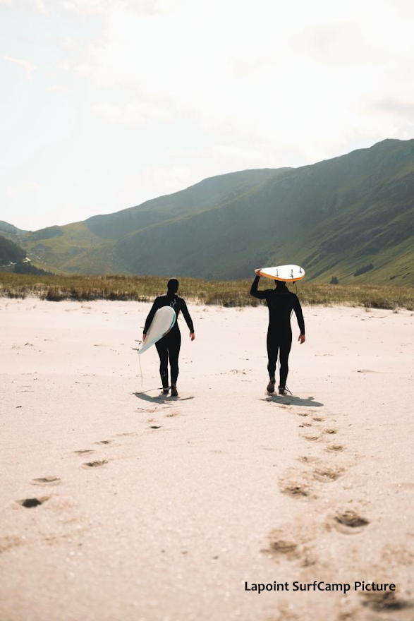 Two surfers heading back to town in Hoddevik, Norway