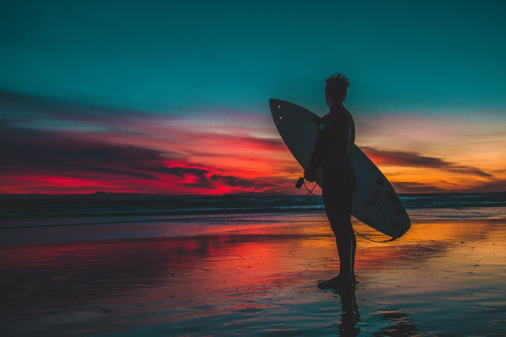 A surfer looking at a sunset in Norway
